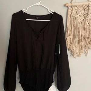 Black lace-up body suit from Free Press Clothing